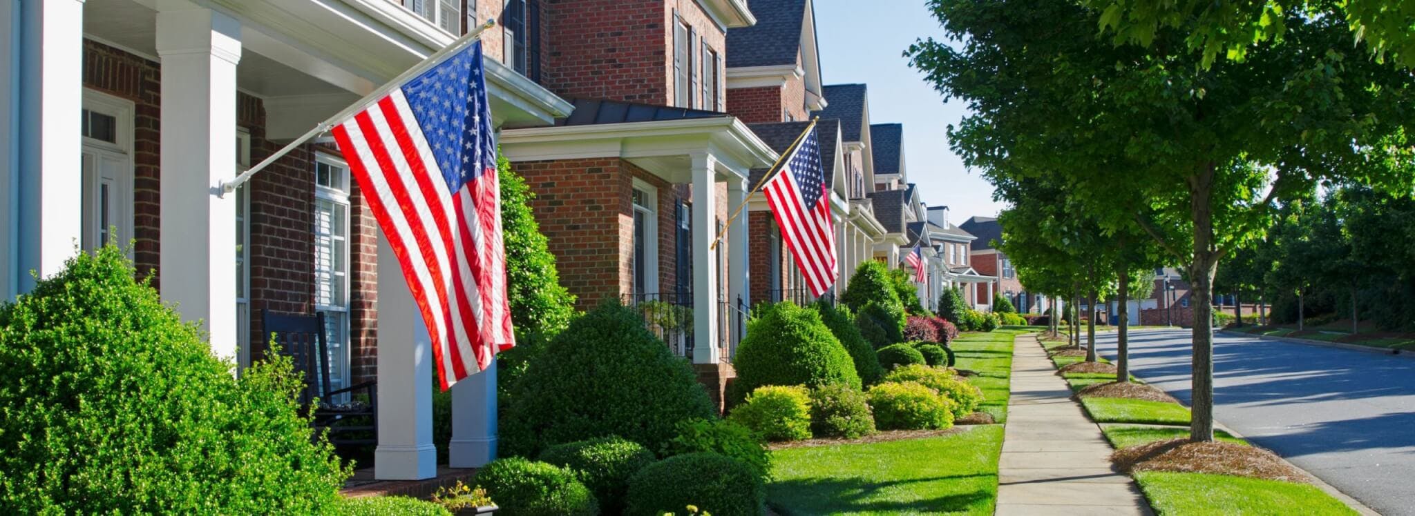 row of houses with American flags