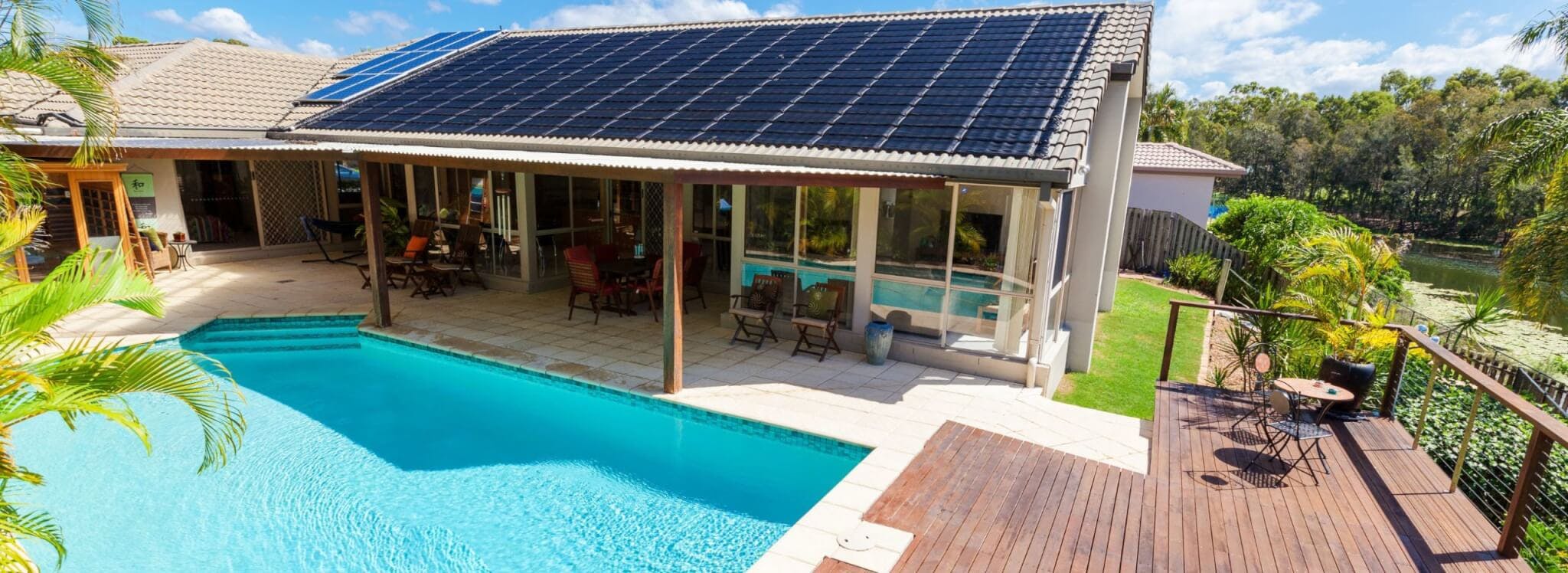 house with solar panels and pool