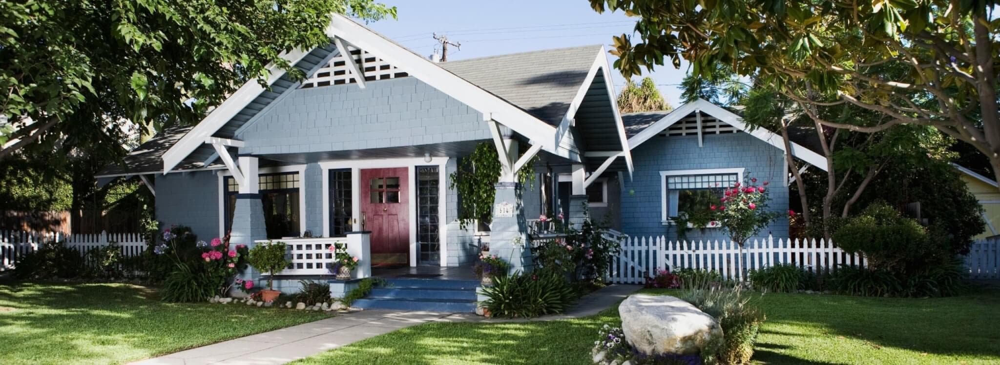 green lawn in front of blue home