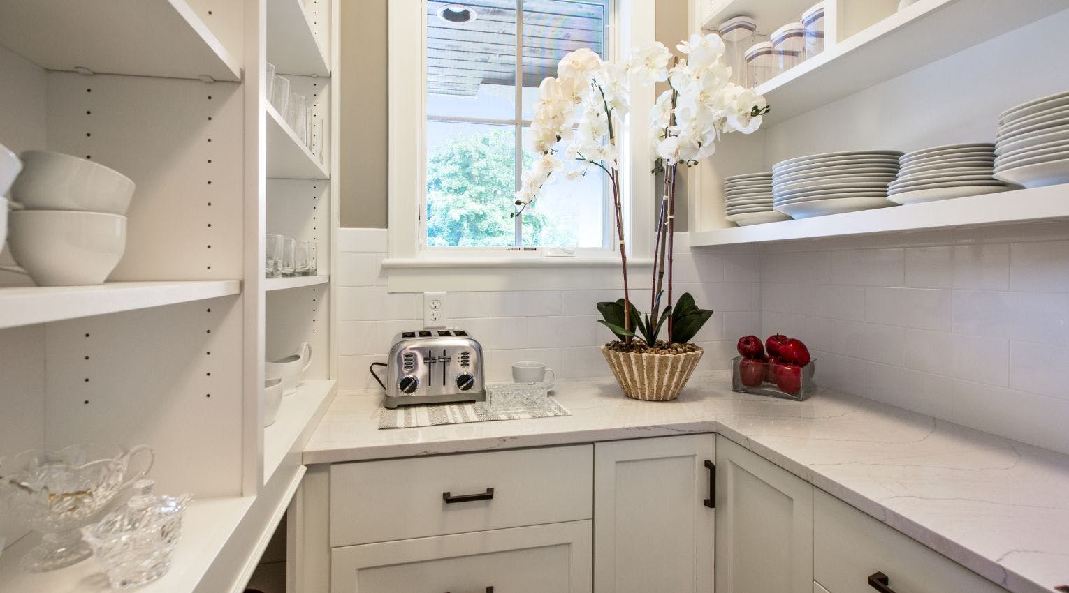 White counters and cabinets in a pantry 